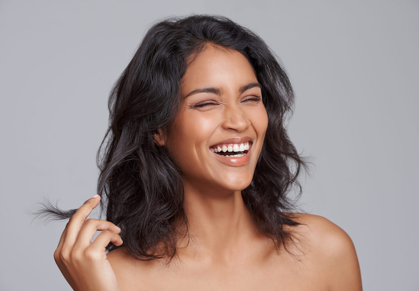 Smiling woman touching her hair