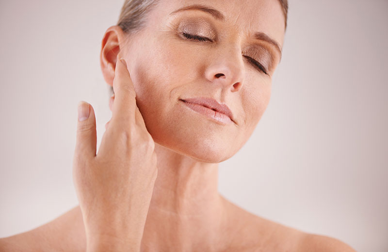 Woman touching her face, clear skin