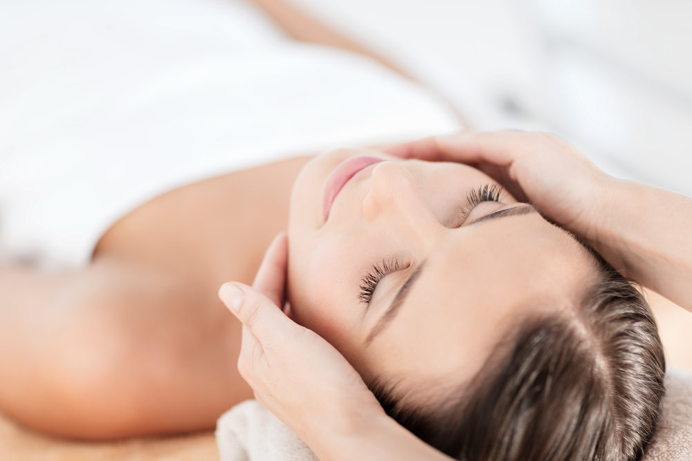 beautiful woman in spa salon getting face treatment