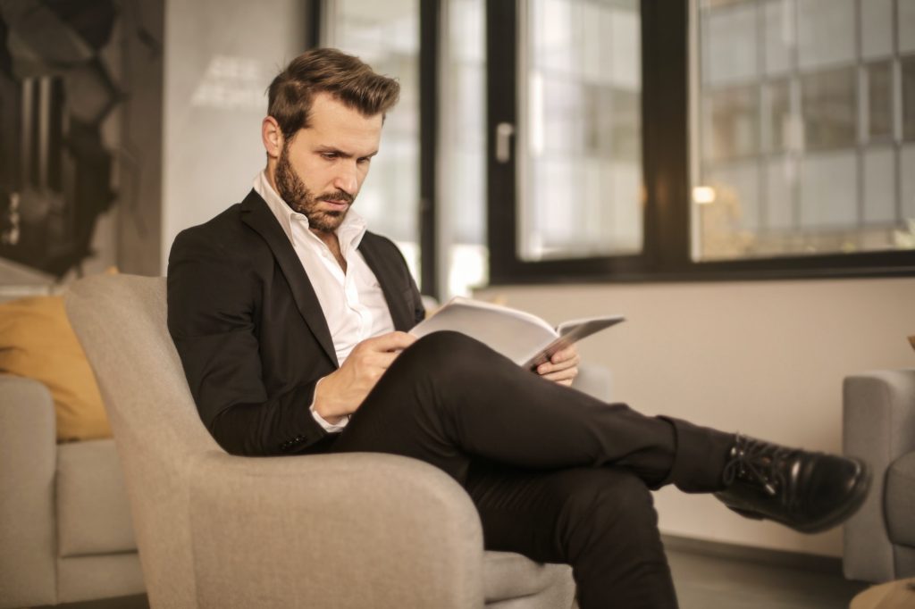 Distinguished looking man sitting in chair with full head of hair